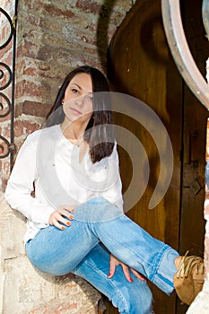 Girl standing at the old wooden door