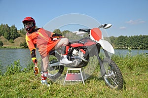 Girl standing on one foot, the other on the bike