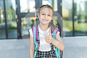 Girl Standing Outside School With Bag