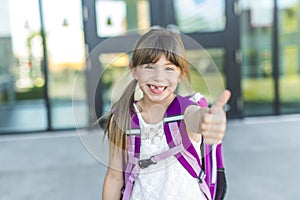 Girl Standing Outside School With Bag
