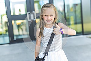 Girl Standing Outside School With Bag