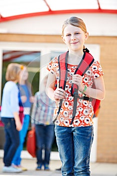 Girl Standing Outside School With Rucksack