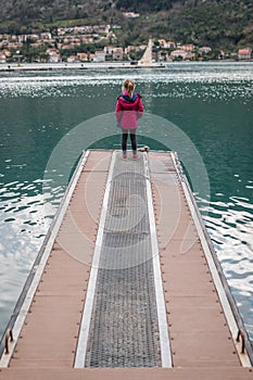 Girl standing on a pier in Kotor Bay