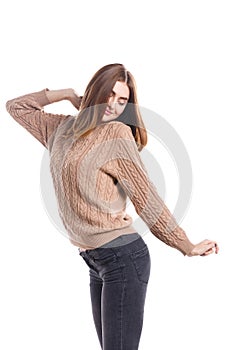 Girl standing sideways snuggles up on a white background