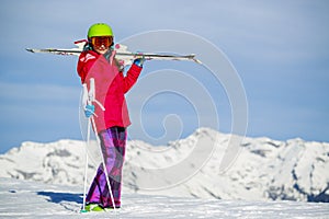 Girl standing with ski on the arms.