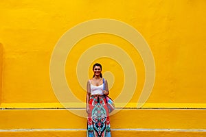 Girl standing on a street wall in Valladolid, Mexico