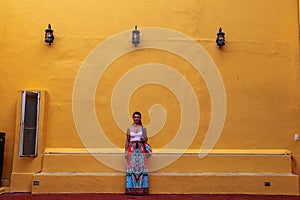 Girl standing on a street wall in Valladolid, Mexico