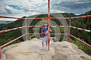 Girl standing on top of rock