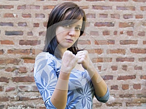 Girl standing up and preparing to fight