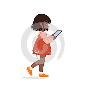 Girl standing and using her tablet.