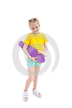 Girl standing with violete skateboard isolated