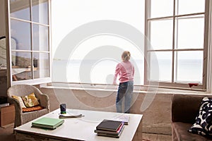 Girl Standing At Window And Looking At Beautiful Beach View