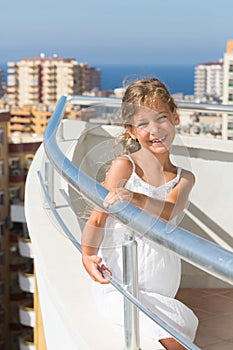 A girl stands on the balcony of the hotel