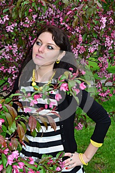 A girl stands at the cherry blossoms