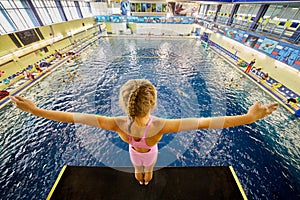 Girl stands on diving-tower in Universal sports photo