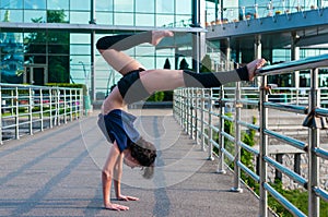 Girl stands on the hands, upside down. Acrobatics