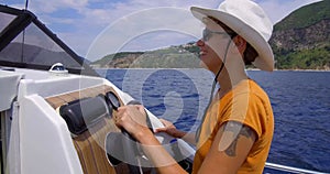 Girl stands at the helm of a motor boat