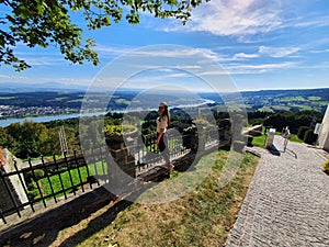 girl stands with his back to the camera. against the background of a beautiful landscape photo