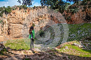 A girl stands and looks at the mountain. A place for climbers at Crete island, Greece