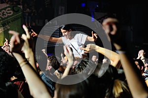 A girl stands over the crowd in a concert at Razzmatazz discotheque