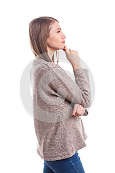 A girl stands sideways with a pensive look. Isolated on white background.