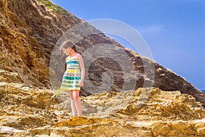 Girl stands on top of cliff. Bali, Crete