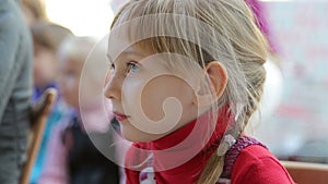 The girl stares theatrical performance and contagious laughs