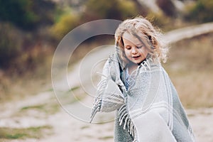 girl stay covered with blanket in park