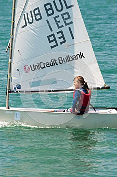 Girl - steering a sailing yacht in the bay of of Pomorie, Bulgaria