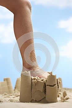 Girl Stepping On Sand Castle