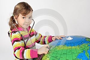 Girl with stethoscope and big inflatable globe