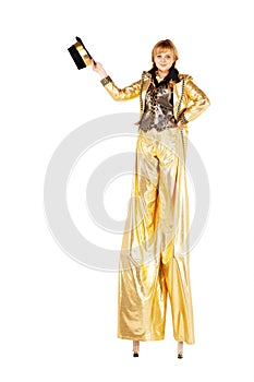 Girl on stilts dressed in gold