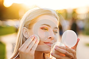 Girl straightens makeup on street