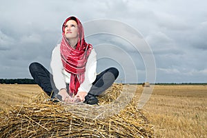 Girl is on a straw stack
