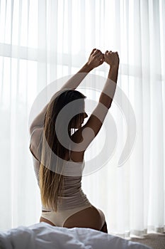 girl streching in bed