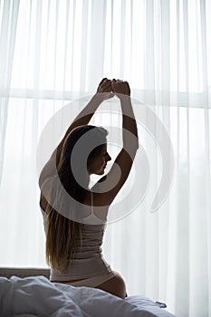 Girl streching in bed