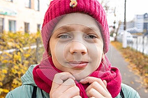 Girl on  street in autumn in  hat and scarf