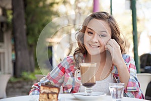 Girl in the street drink a capuccino