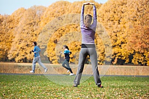 Girl stretching in park photo