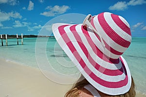 Girl in a striped hat on the beach