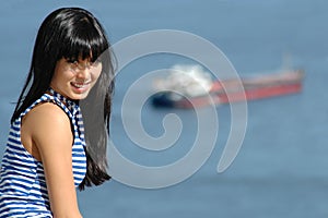 Girl in striped sailor's vest on ship background