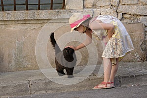 Girl stroking cat photo