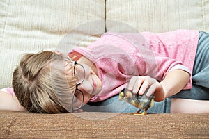 Girl stroking a chick