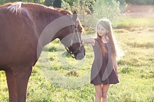 Girl stroking her horse