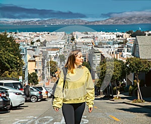 Girl strolls through the steep streets of San Francisco during her USA vacation