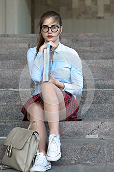 Girl student with books in her hand