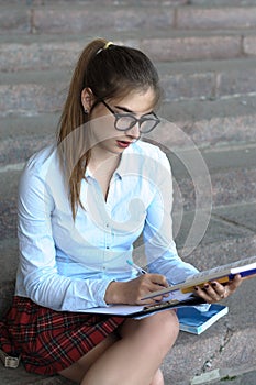 Girl student with books in her hand