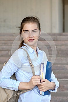 Girl student with books in her hand