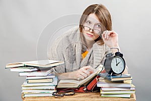 Girl student with glasses reading books