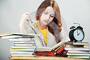 Girl student with glasses reading books